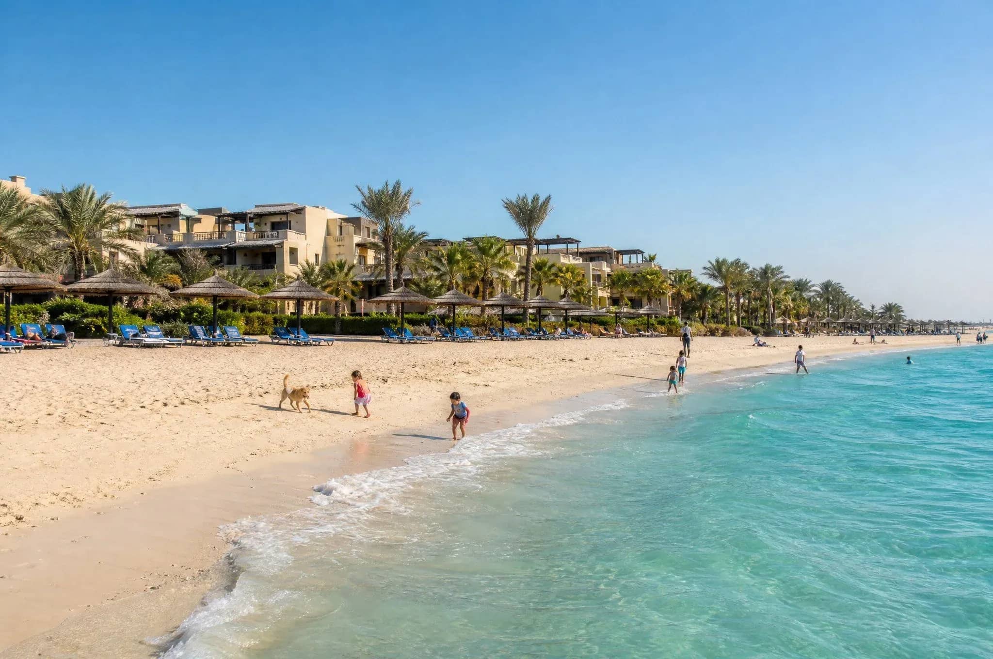 Sandy beach and turquoise water beside waterfront buildings